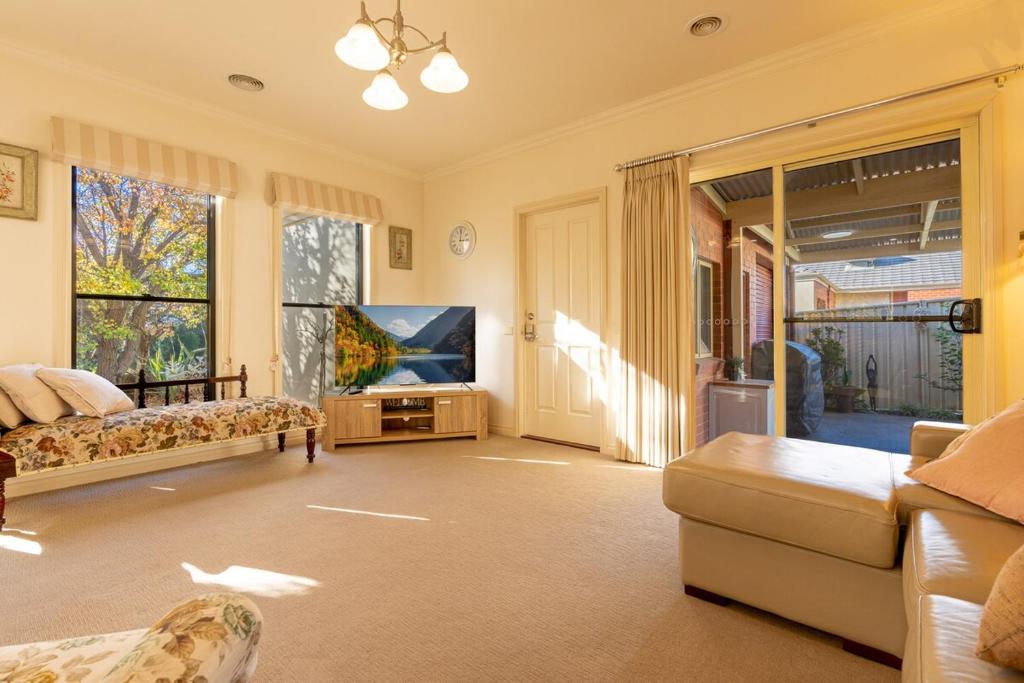 a living room with a couch and a flat screen tv at Comfort & Quiet 3BR, CBD 5mins in Kennington
