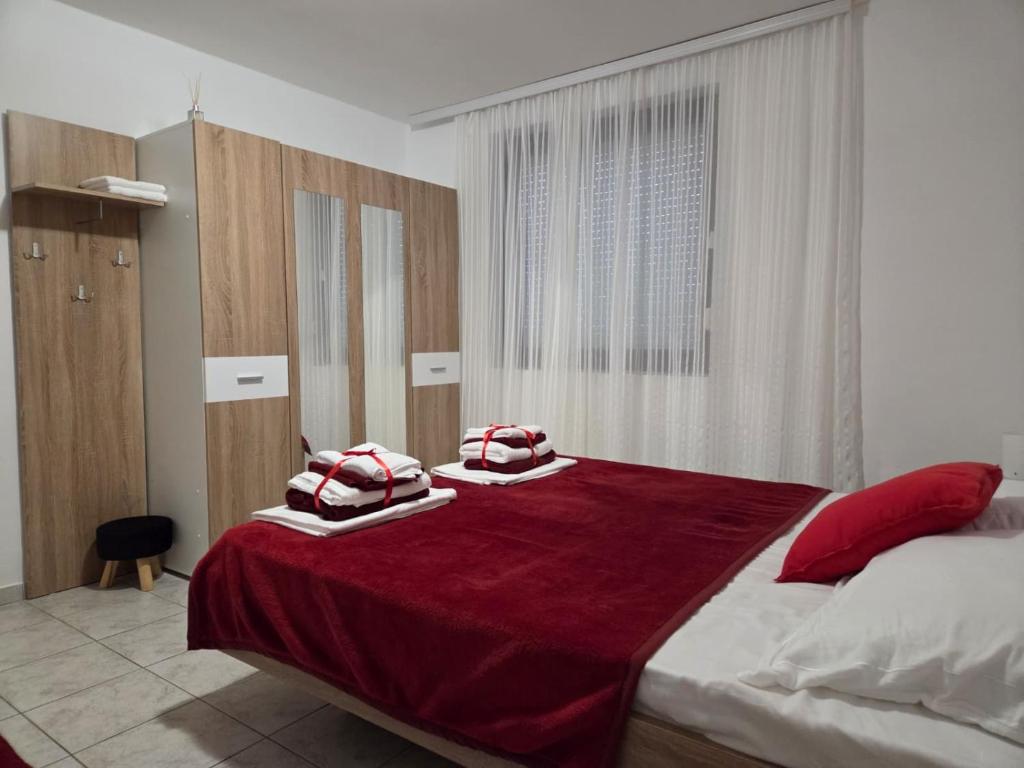 a bedroom with a bed with two pillows on it at Villa Bianca in Baška