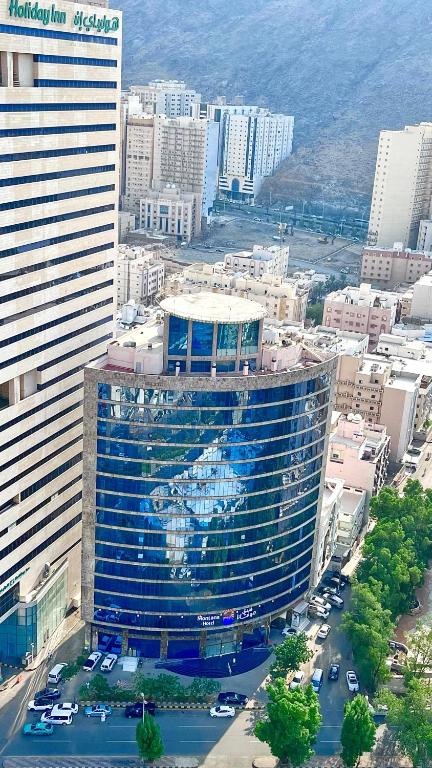 a large building with a mural on it in a city at Montana Golden Hotel in Mecca