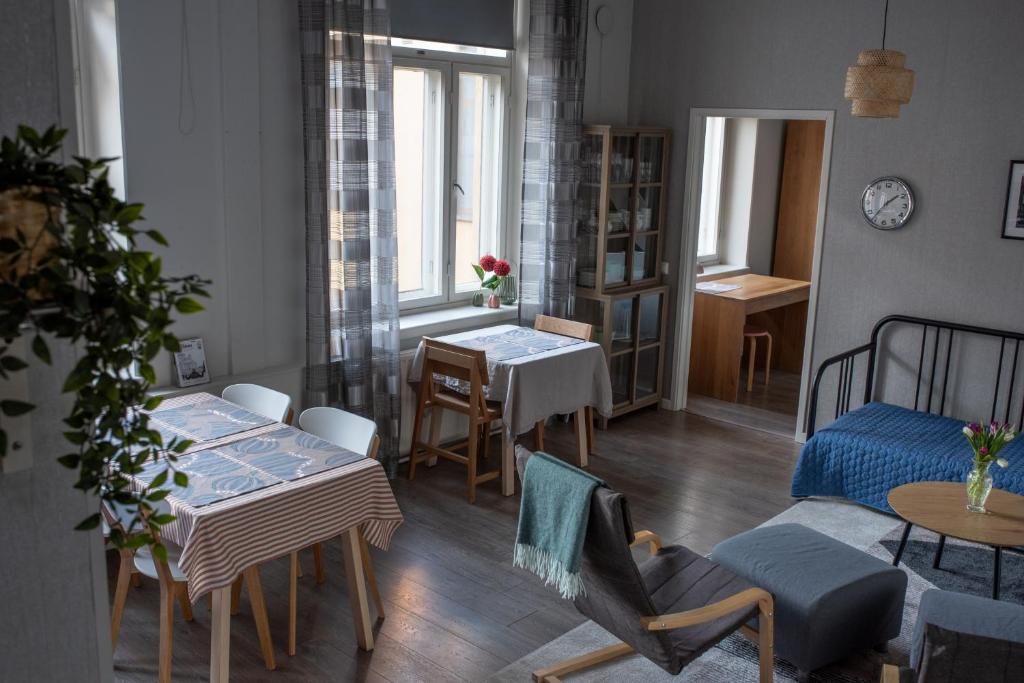 a living room with a bed and a table at Diana Park Apartments in Helsinki