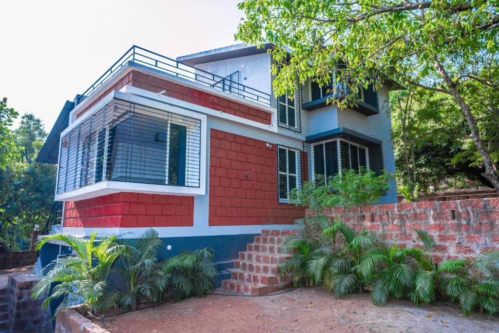 a red and white house with a tree at Swara Villa Your Perfect Getaway in Jāmb