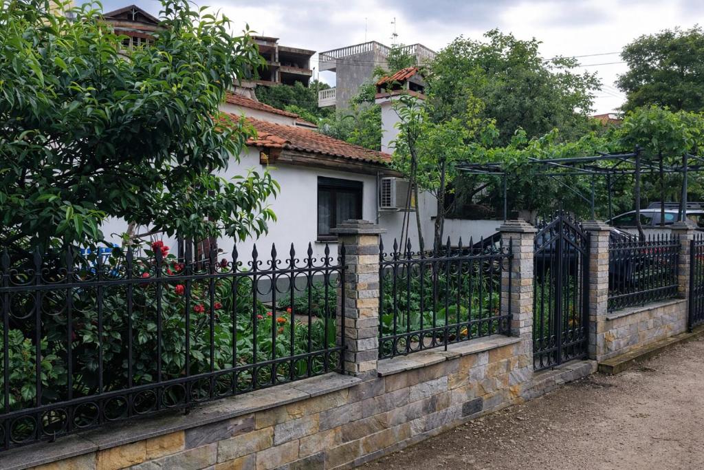 a wrought iron fence in front of a white house at SUNNY STUDIO in Skala Marion