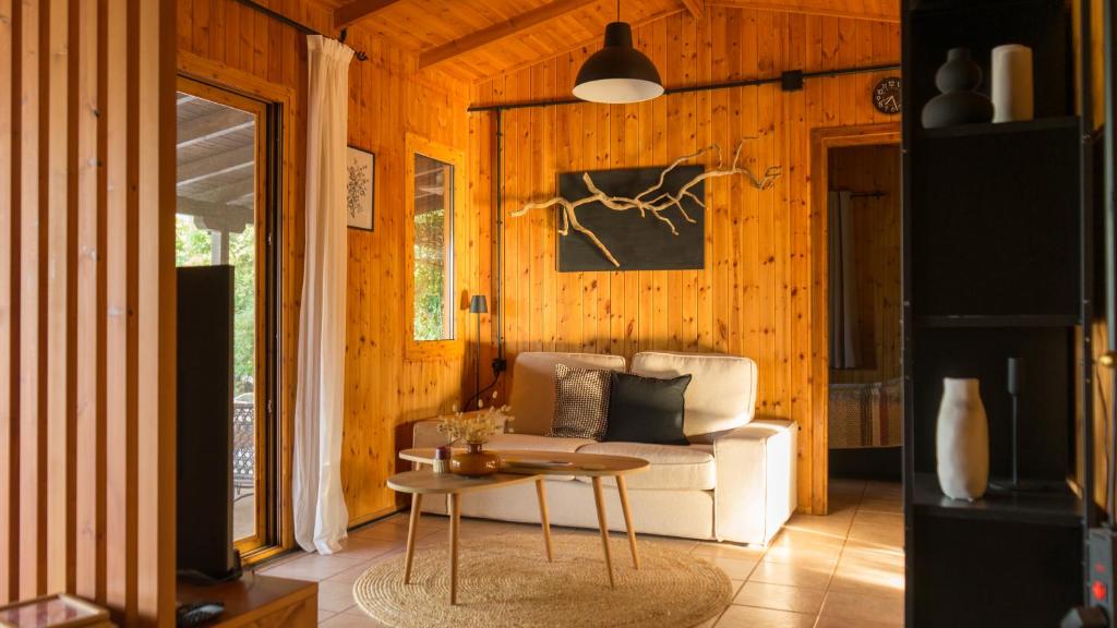 a living room with a couch and a table at Casa Mocha by RentalsPro - Vourvourou Halkidiki in Vourvourou