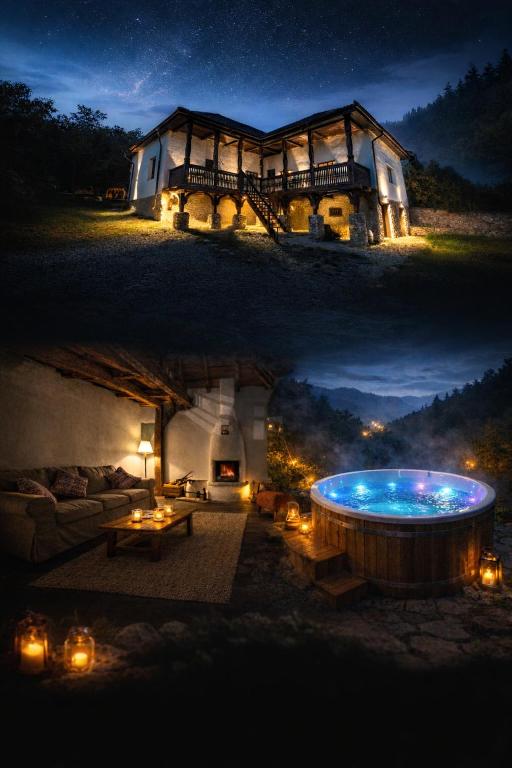 a house with a hot tub in the yard at night at The Carpathian Lodge in Runcu
