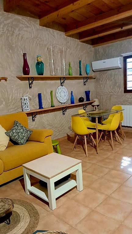 a living room with a couch and a table and chairs at Casita Sol in Villafamés