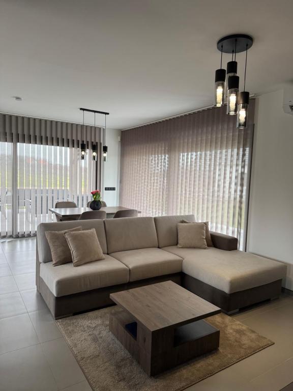 a living room with a couch and a table at BODU Vendégház in Balatonberény