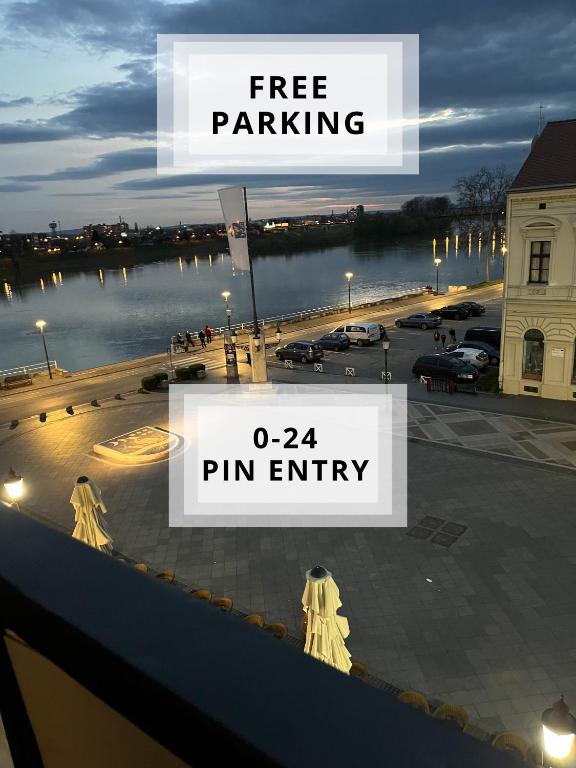 a sign that says free parking and a pin entry at Apartman Loft 72 in Slavonski Brod