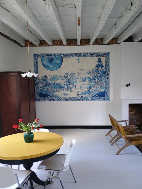 a dining room with a yellow table and chairs at Villa Paignon Gite in Montbron