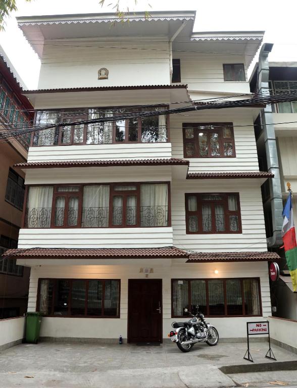 a motorcycle parked in front of a building at OS Hotel Pomra in Gangtok