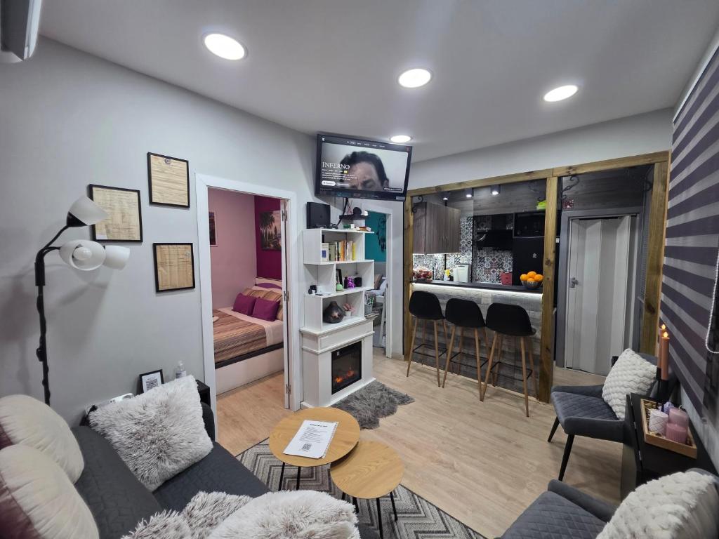 a living room with a couch and a room with a bedroom at Casa Atocha 1913 Apartamento Histórico con Encanto in Madrid