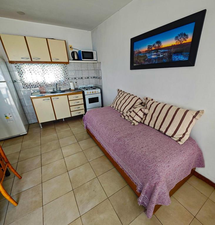 a small kitchen with a couch in a room at Depto AC Olavarria in Olavarría