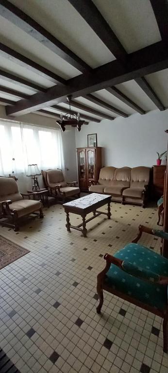 a living room with couches and a table in it at Coquette maison in Dunkerque