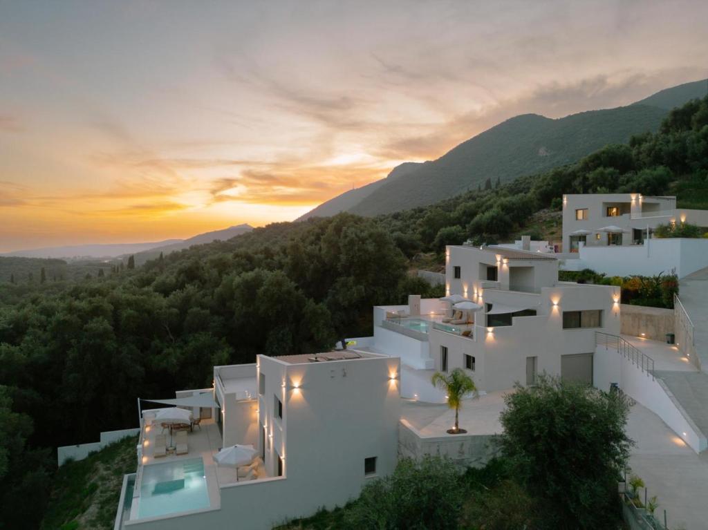 a view of a white house at sunset at Meliora Exclusive Villas Parga in Parga