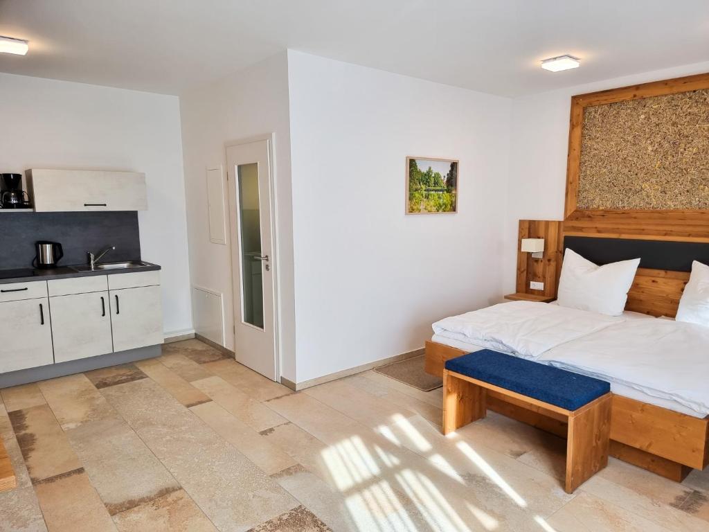 a bedroom with a large bed and a kitchen at Appartement 1 mit Terrasse in Wehlenberg