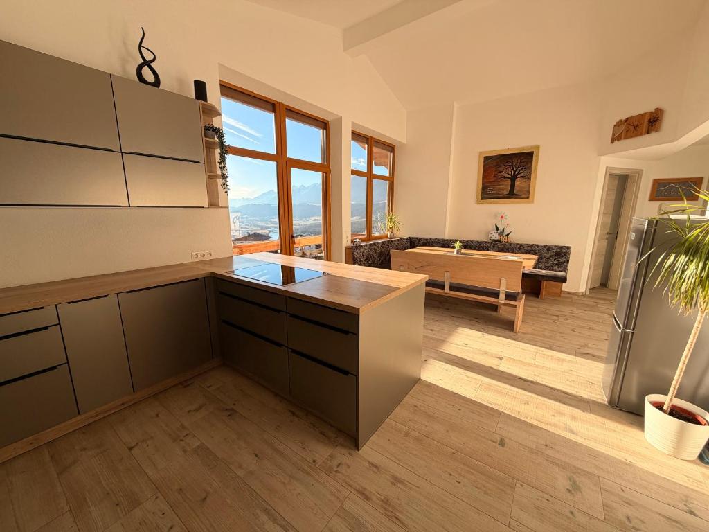 a kitchen with a refrigerator and a living room at Gruberhof in Pill