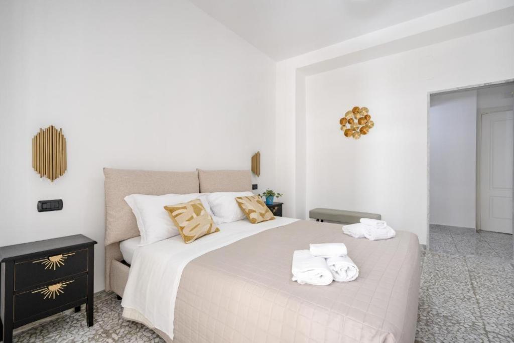 a bedroom with a large bed with towels on it at AuGuStea - Modern Central Suites in Bari