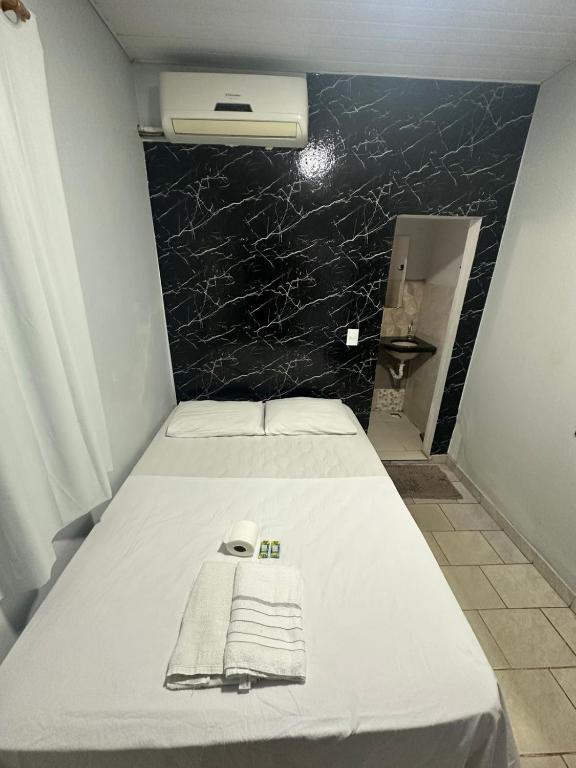 a bedroom with a bed with towels on it at Hotel São Cristóvão in Marabá