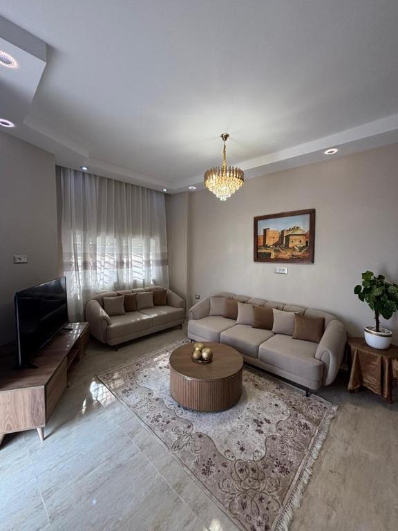 a living room with two couches and a coffee table at Dar Lina in Tozeur