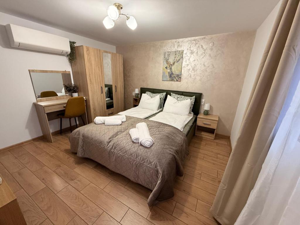 a bedroom with a bed with two towels on it at Villa Solina in Sapareva Banya