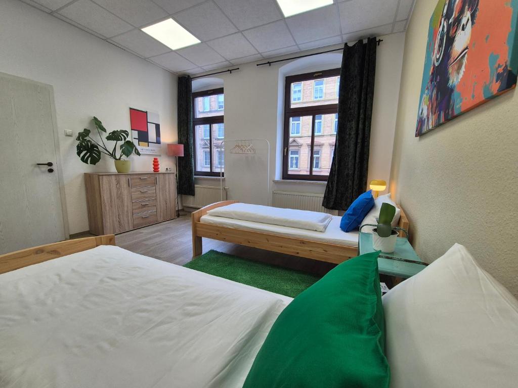 a large room with two beds and a window at Wohnung mit Balkon in Zwickau