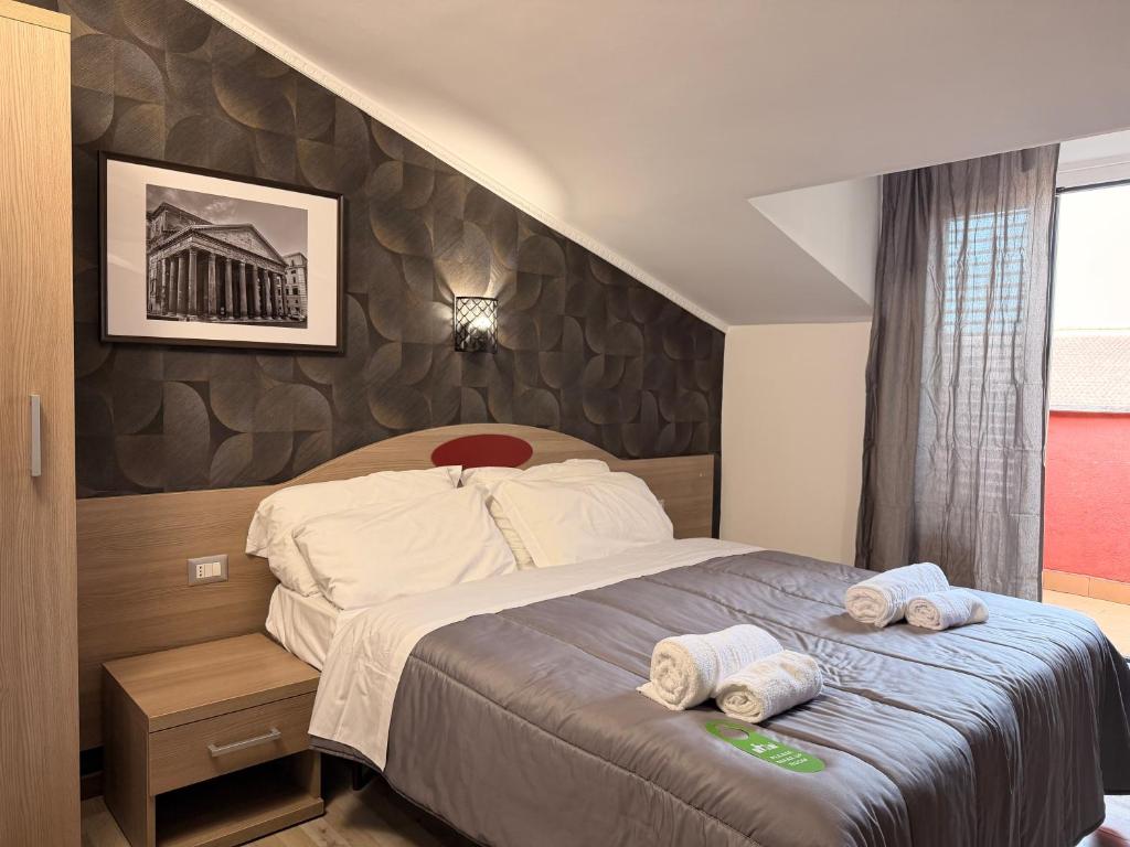 a bedroom with a bed with two towels on it at Hotel Concorde in Rome