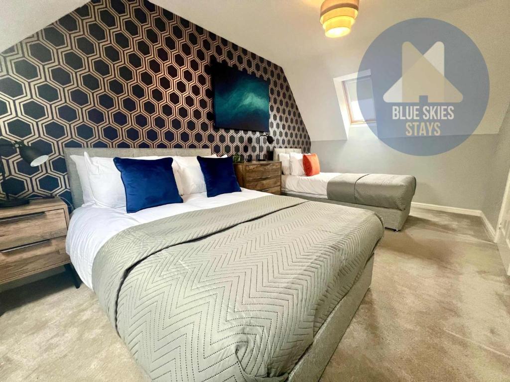 a bedroom with a king sized bed and a couch at Puffin House in Seaton Carew