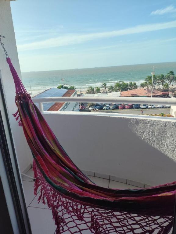 a hammock on a balcony with a view of the ocean at Mar à vista in São Luís