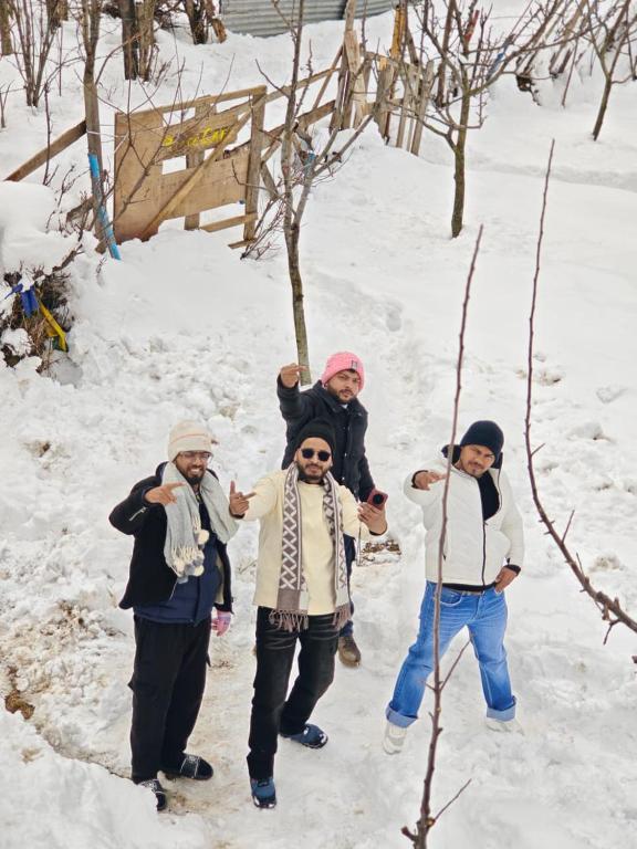 a group of people standing in the snow at Peace homestay n cafe in Kalgha