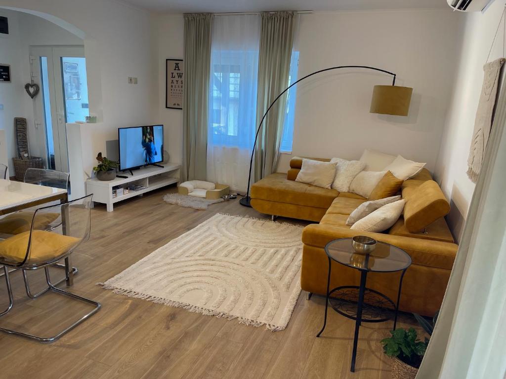 a living room with a couch and a tv at Angyalkert in Balatonszárszó