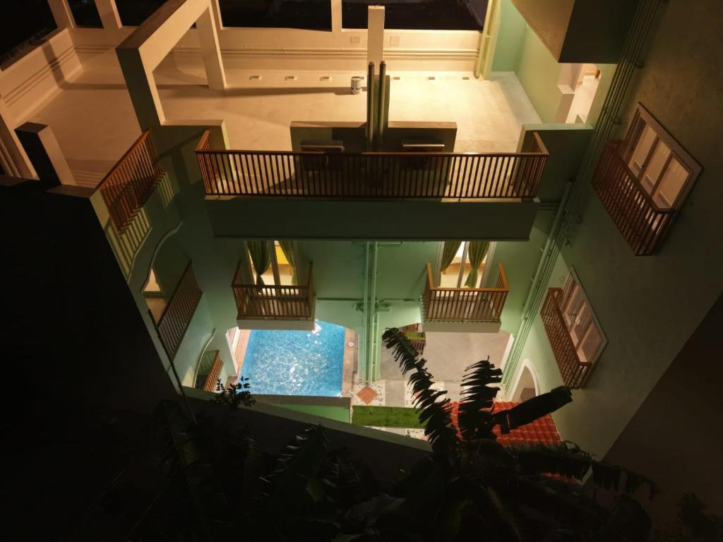 an overhead view of a building with a swimming pool at Green Resort Pondicherry in Pondicherry
