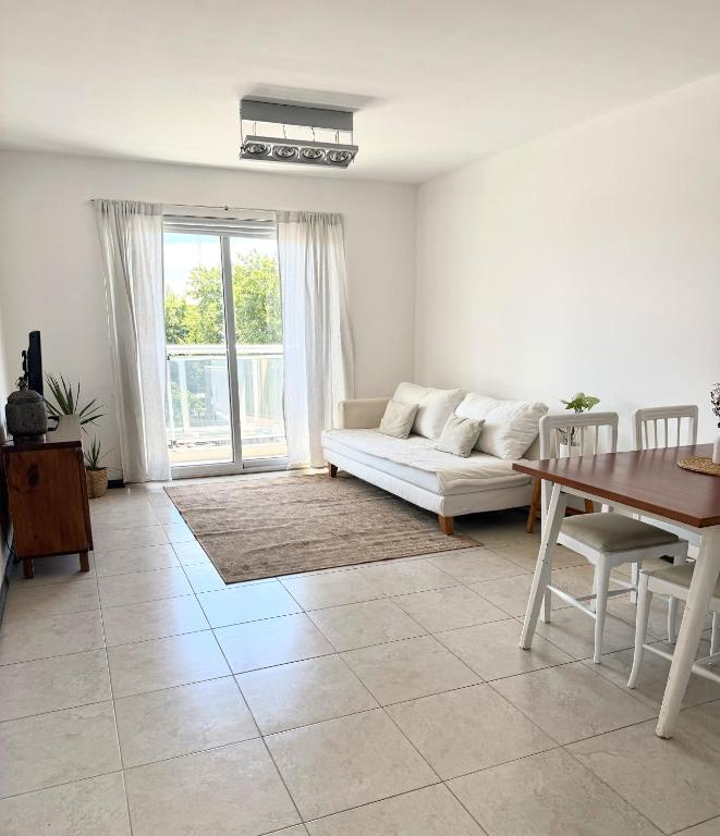 a living room with a couch and a table at R Haus 2 Con Cochera in Concordia