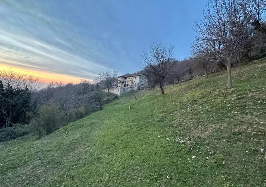 a house sitting on top of a grassy hill at Cascina Buren in Brescia