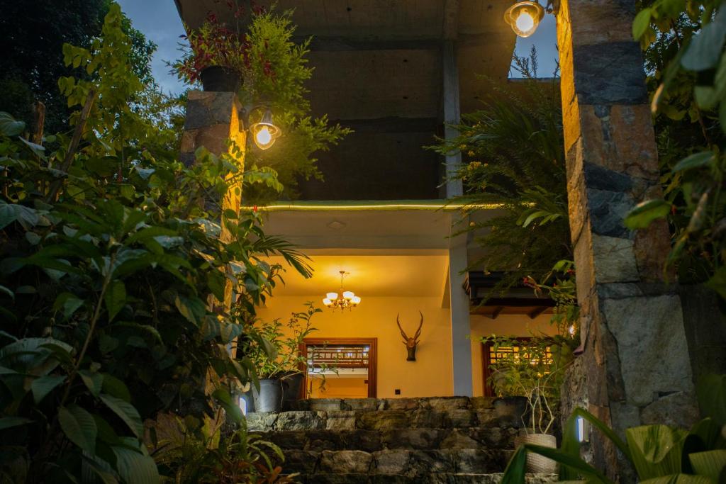 an entrance to a house at night with lights at Asoria Luxe Resort in Kegalle