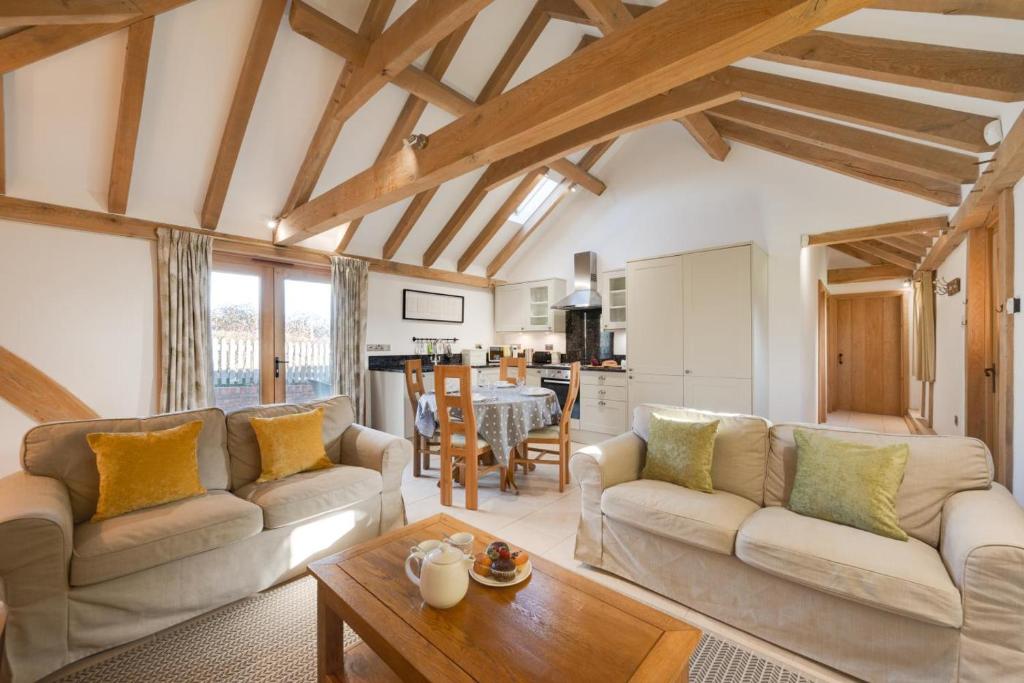 a living room with two couches and a table at 2 Bed in Tenterden oc-tn607 in Stone
