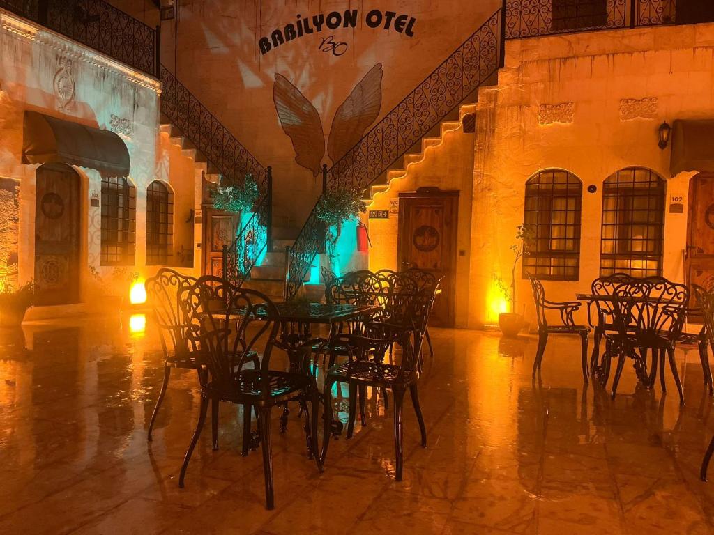 a dining room with tables and chairs in a building at Babilyon Otel in Urfa