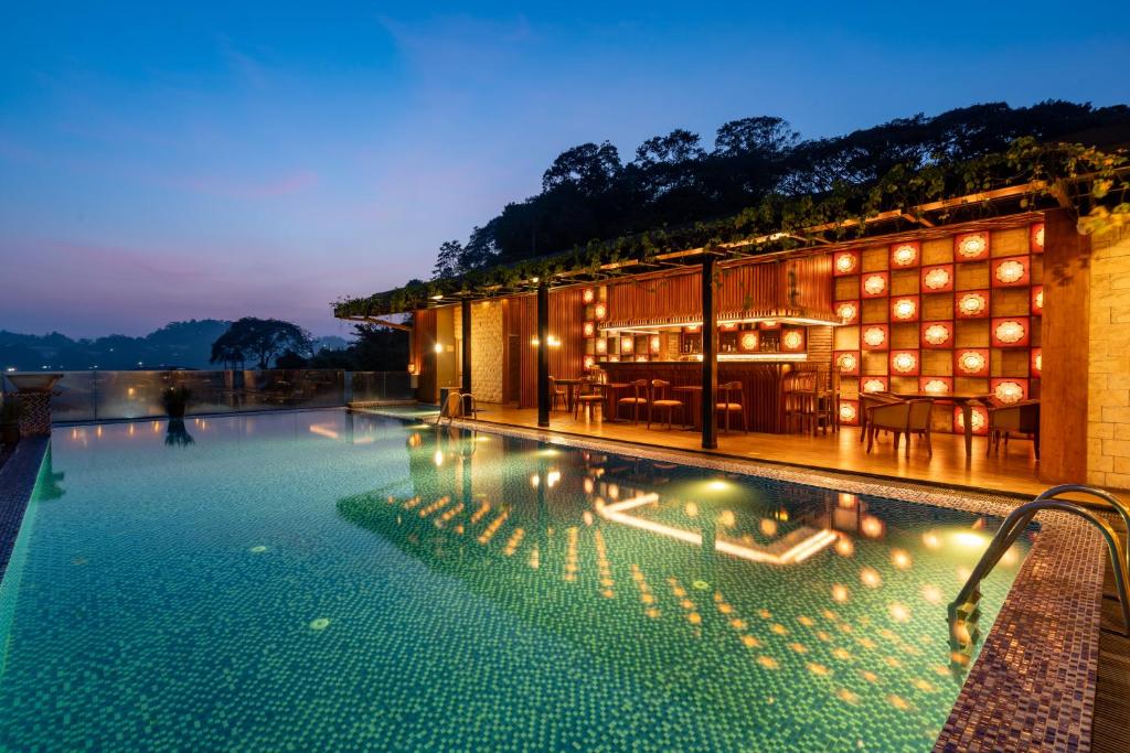 a hotel swimming pool at night with lights at Serene Kandy in Kandy