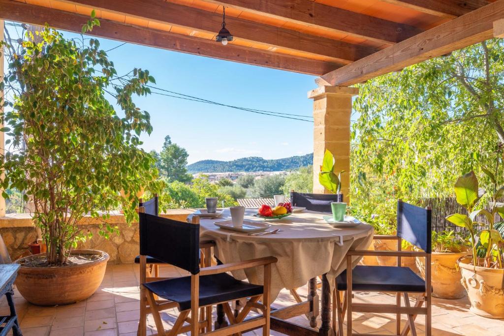 a table and chairs on a patio with a view at Ca Na Carme (Alaronera) in Alaró