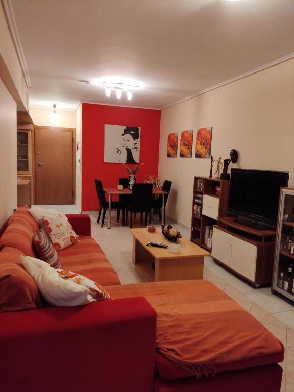 a living room with a couch and a table at Dancer's Home in Korinthos