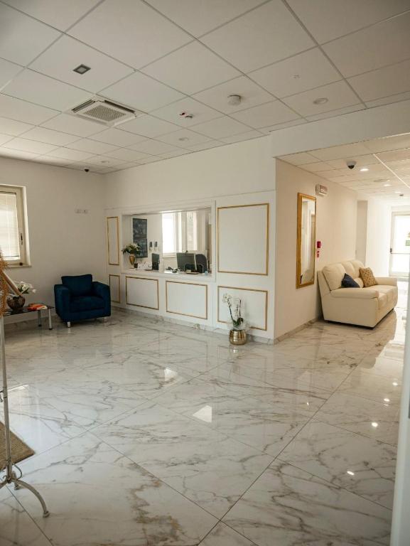 a large living room with two chairs and a couch at ROOMS alCentro in Catania