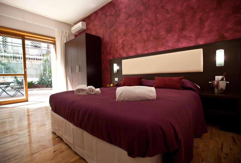 Ένα ή περισσότερα κρεβάτια σε δωμάτιο στο Heart of Rome Rooms