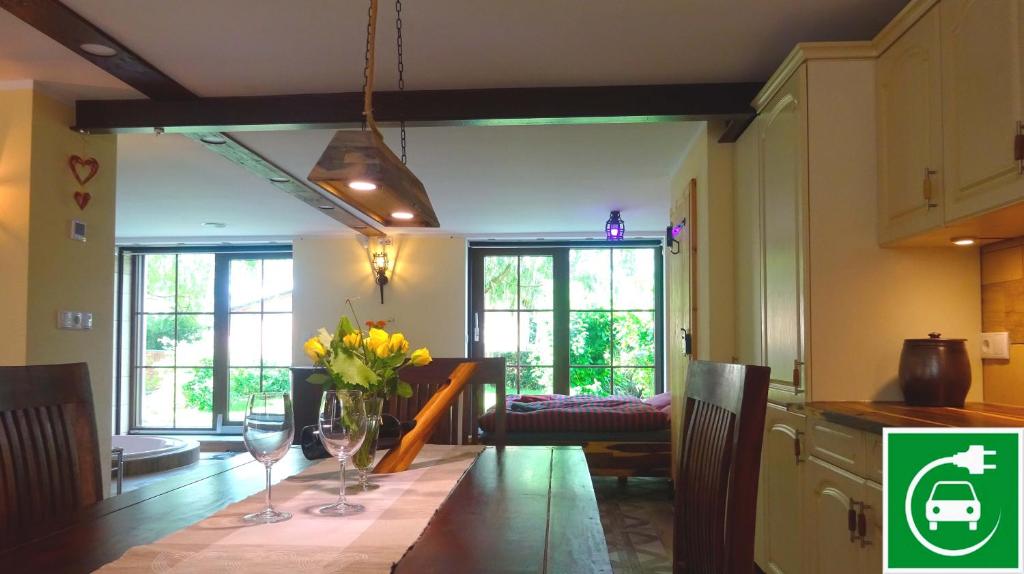 a kitchen with a table with flowers and wine glasses at Auszeit Posthausen in Machern