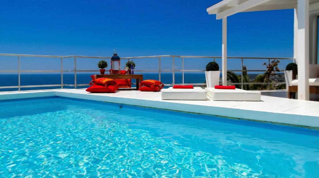 a pool with chairs and a table on a balcony at Villa Sitges Altavista Amazing View South oriented Calm Area AC Beach 2 minutes Drive and 18 minutes Walk in Sitges