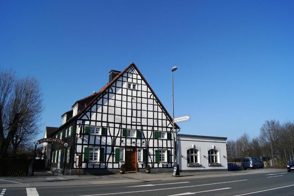 an old black and white building on the street at Westfalenkrug in Wuppertal