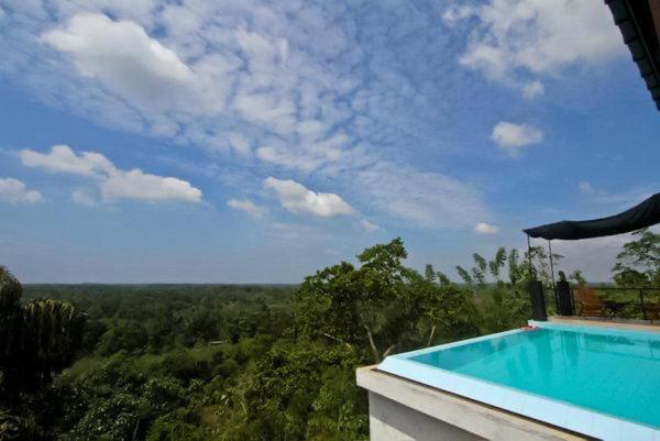 a swimming pool on the side of a house at The Ellen Horizon in Baddegama