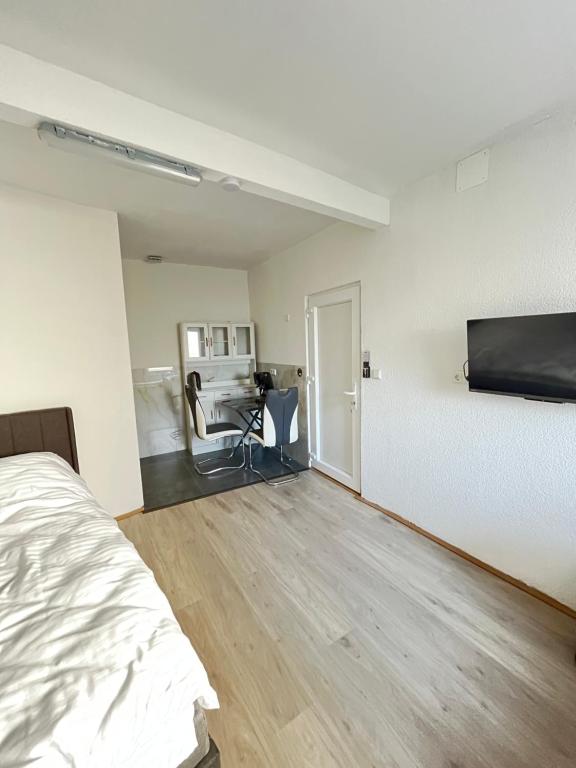 an empty room with a bed and a desk at Ferienwohnung Fatlume No 7 in Bad Honnef am Rhein