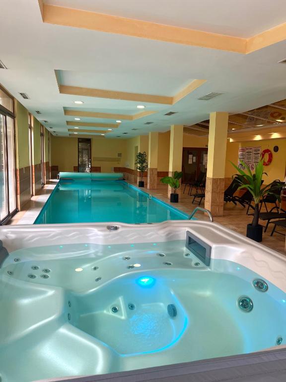 a jacuzzi tub in a swimming pool at Dorina Wellness Apartman in Siófok