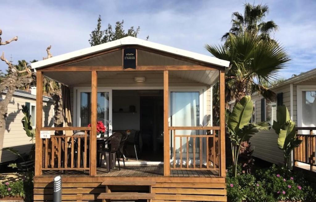 a gazebo on a porch of a house at Camping Enmar - Mobil home 3 pièces 4 personnes climatisé + TV MAE-5300 in Pineda de Mar