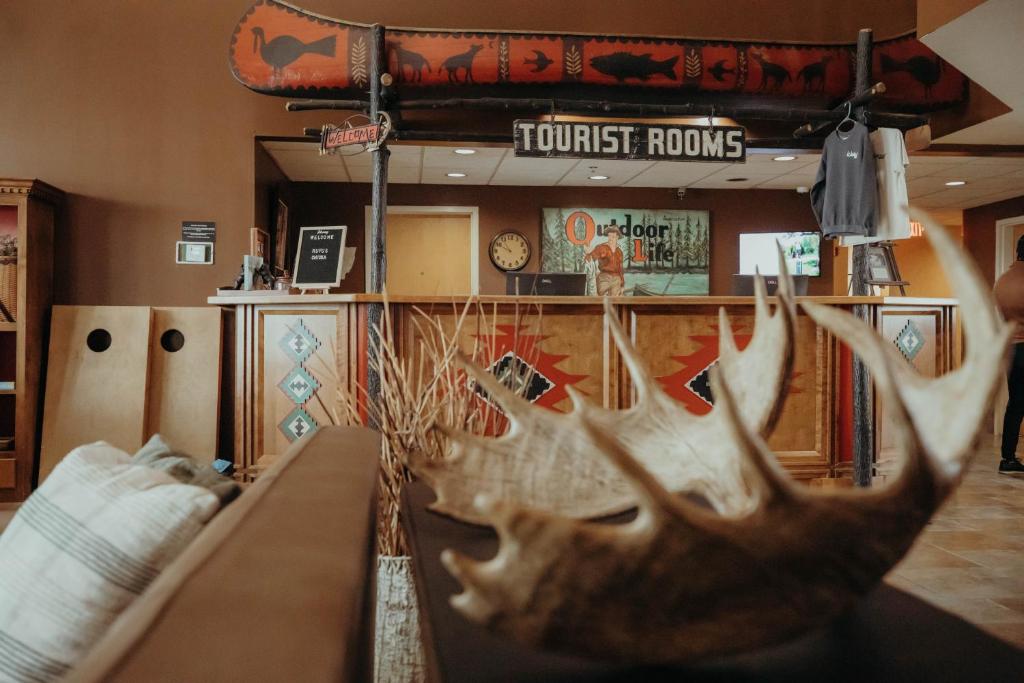 a room with a table with antlers on it at Wildwood Lodge in Pewaukee