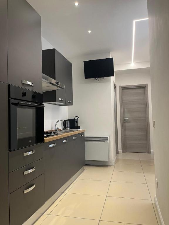 a kitchen with black and white appliances at Caraceni Apartaments 1 in Castel di Sangro