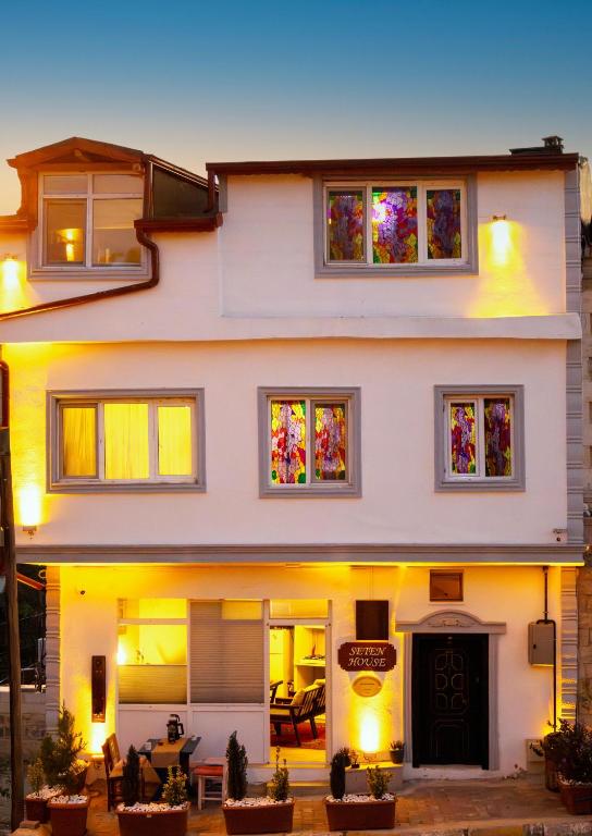 a large white house with stained glass windows at Seten House in Ürgüp